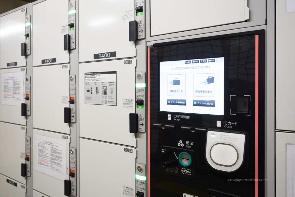 Electronic coin lockers in Japan with a touchscreen panel and IC card payment options.