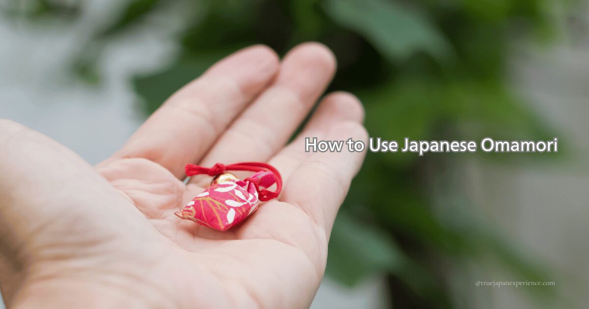 A hand holding a Japanese omamori charm; the image includes the title “How to Use Japanese Omamori”.