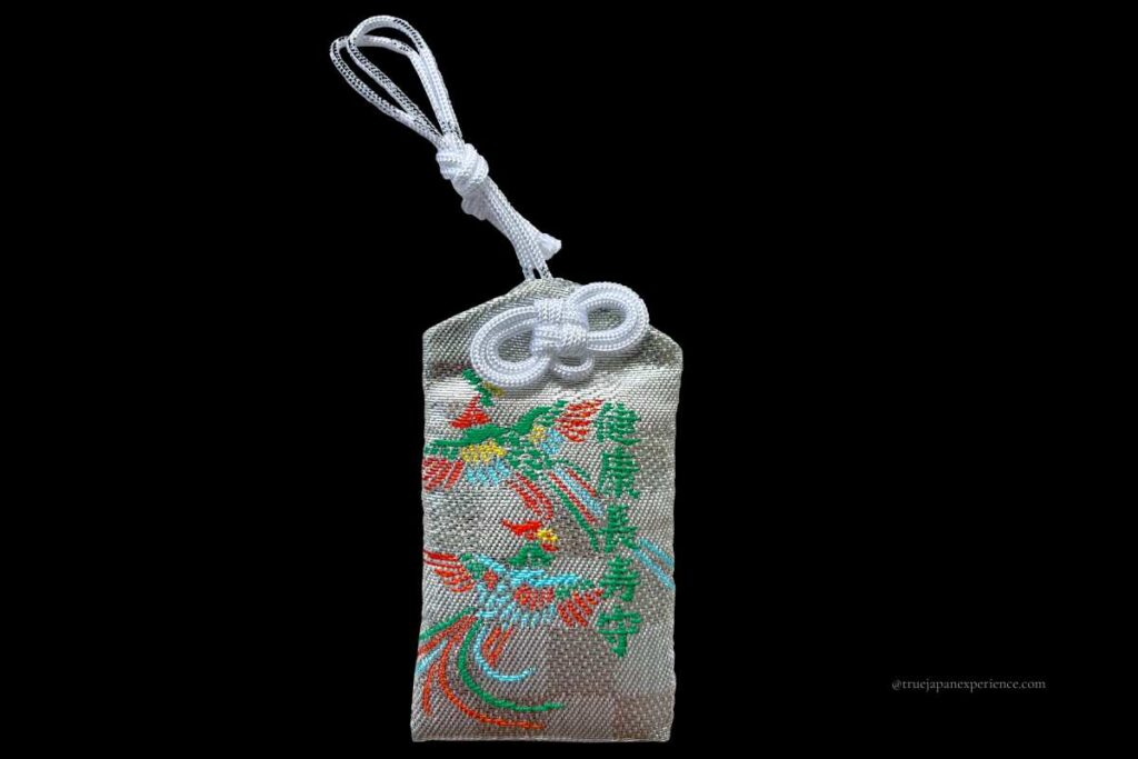 A Japanese omamori for health and long life, embroidered with colorful phoenix-like birds.