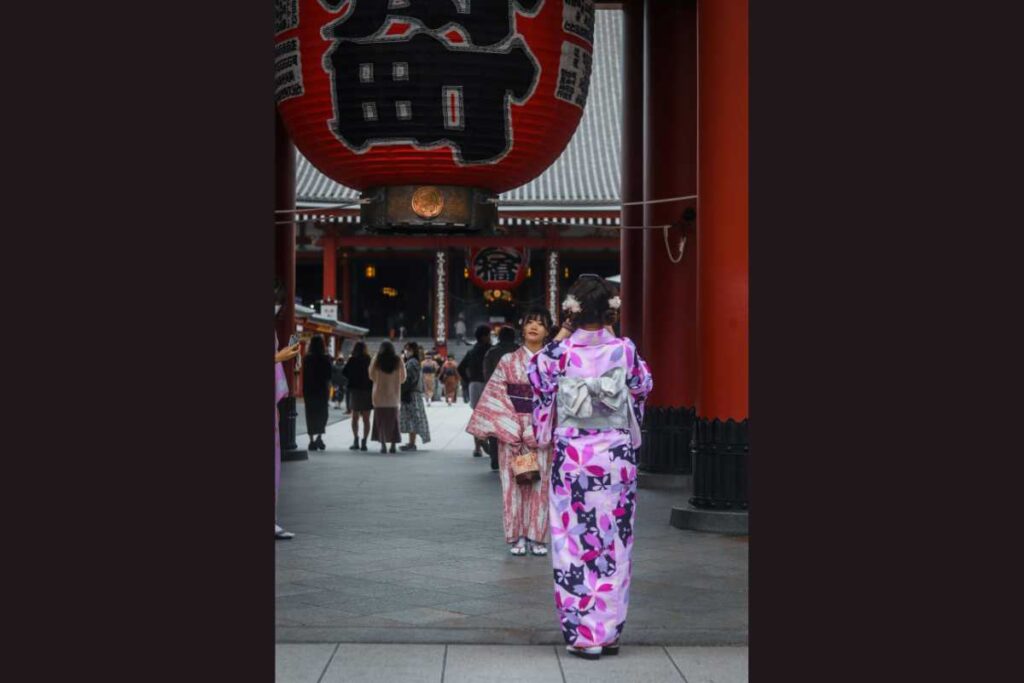 Women in kimono standing beneath the iconic red lantern of Senso-ji Temple in Asakusa