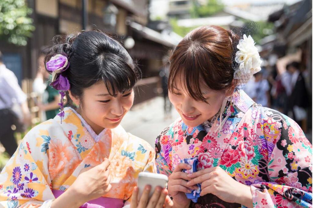 Two women in kimono smiling brightly, enjoying their day in Japan