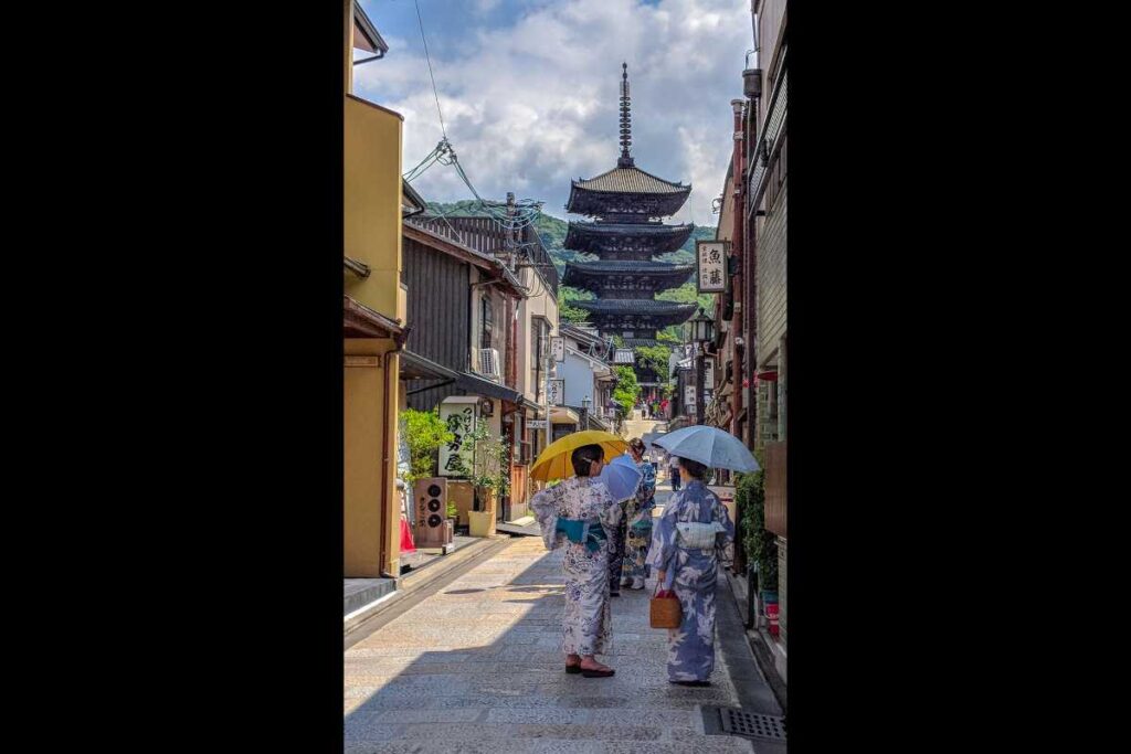 Women in colorful kimono walking toward Yasaka Pagoda in Kyoto’s historic Higashiyama district