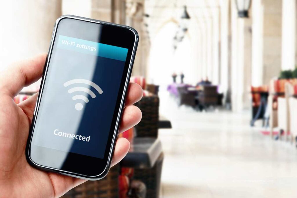 Smartphone showing Wi-Fi settings screen with connected status in a public space
