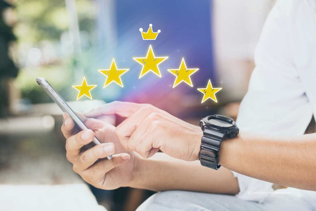 A person using a smartphone with five golden stars and a crown graphic symbolizing a top-rated review or experience.