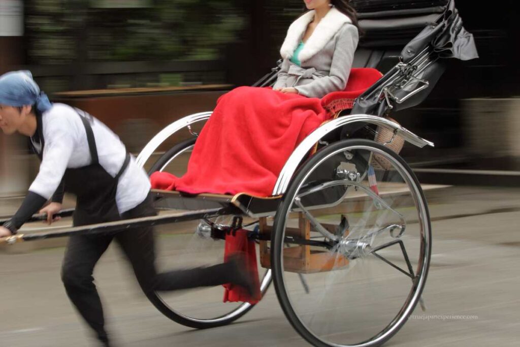 Rickshaw ride in Asakusa with a passenger wrapped in a red blanket