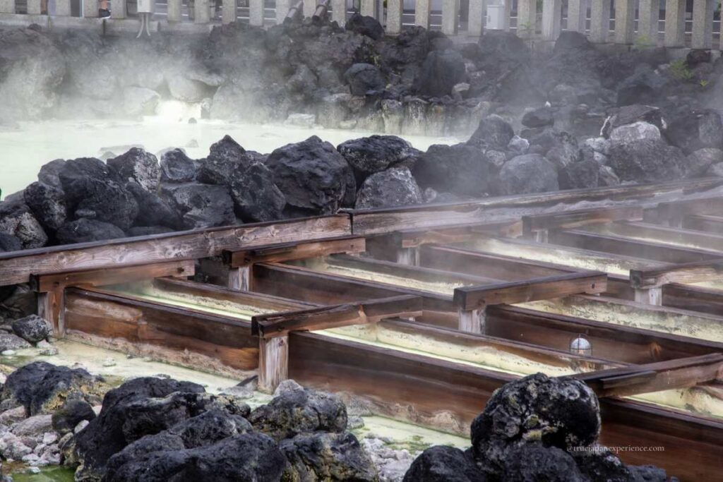 Yubatake hot spring field in Kusatsu, with wooden channels and rising steam