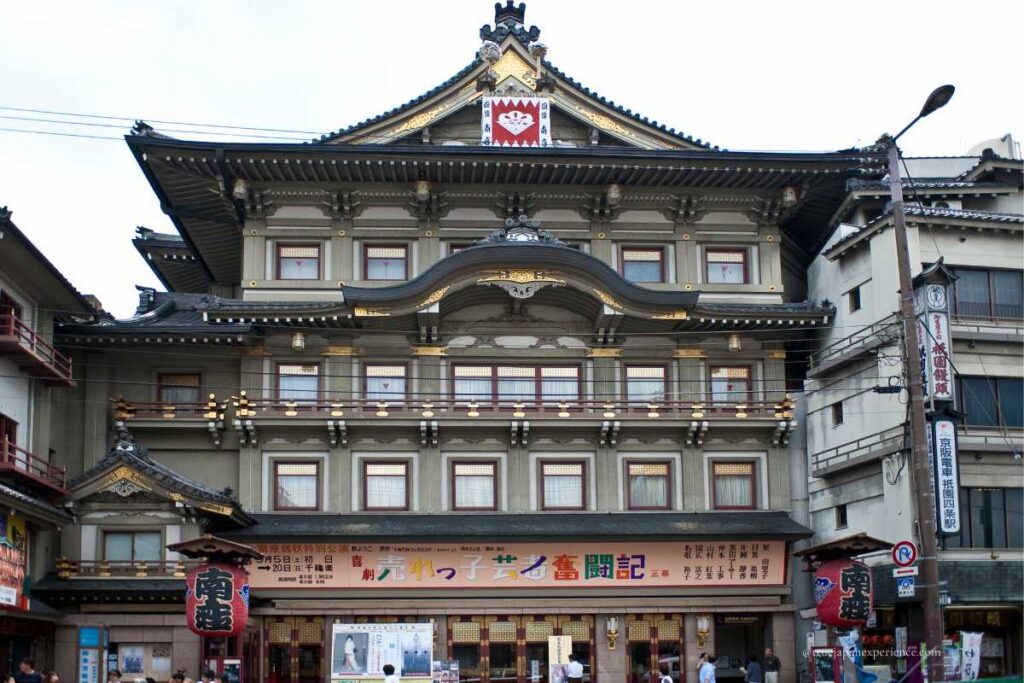 Front view of the Minami-za Theater in Kyoto, a historic kabuki playhouse with traditional Japanese architectural design and colorful signage.