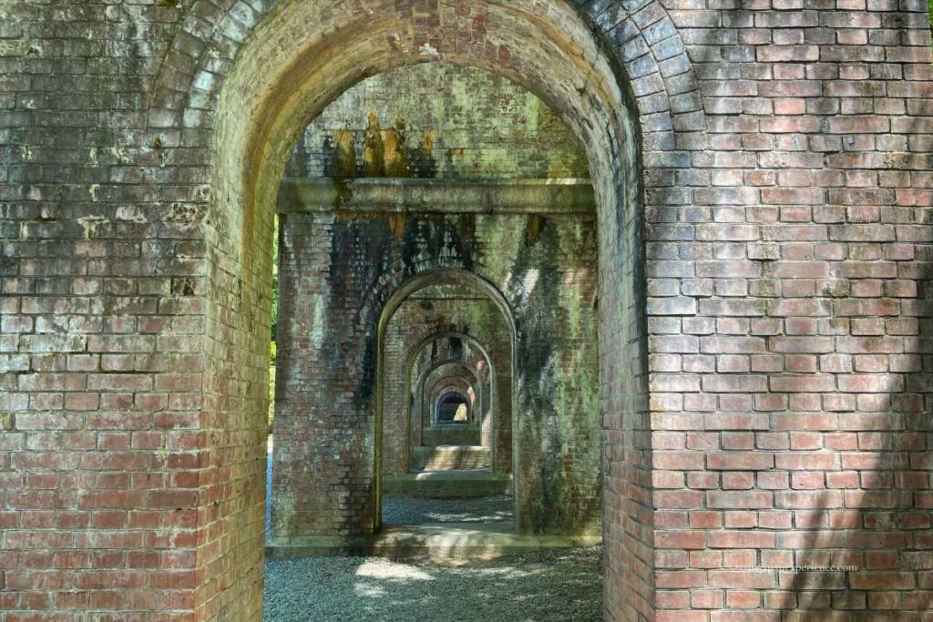 Arched brick passages under the Suirokaku Aqueduct at Nanzen-ji Temple, creating a tunnel-like perspective.