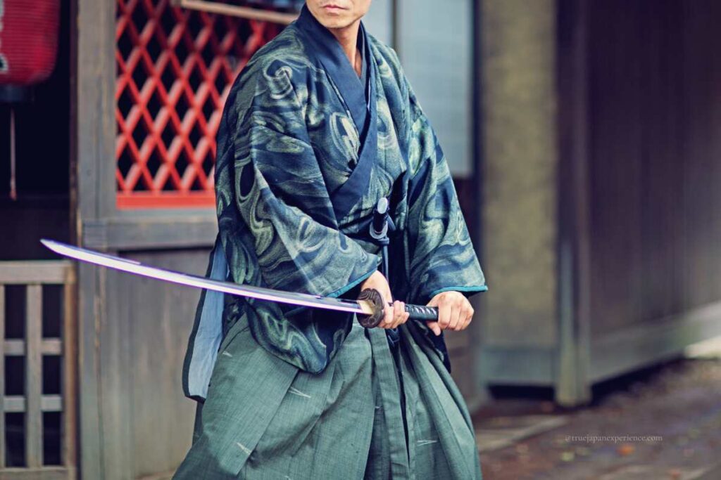 Man in samurai costume holding a katana in a ready stance