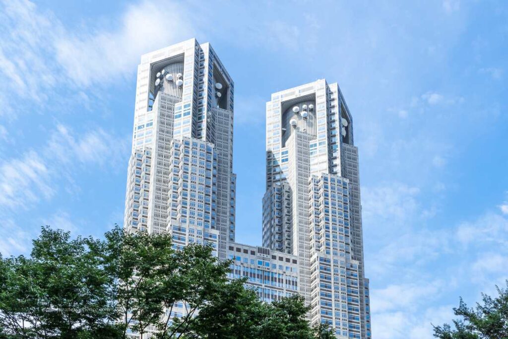 Tokyo Metropolitan Government Building with its twin towers standing tall under a blue sky in Shinjuku.