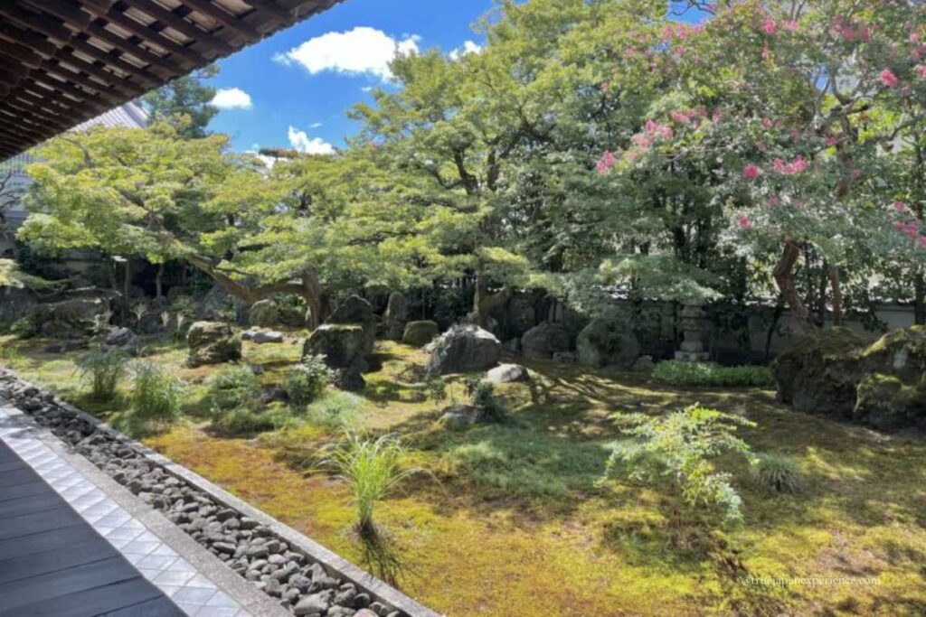 Tranquil Zen garden with moss, rocks, and seasonal trees at Daruma Dera Temple Kyoto.