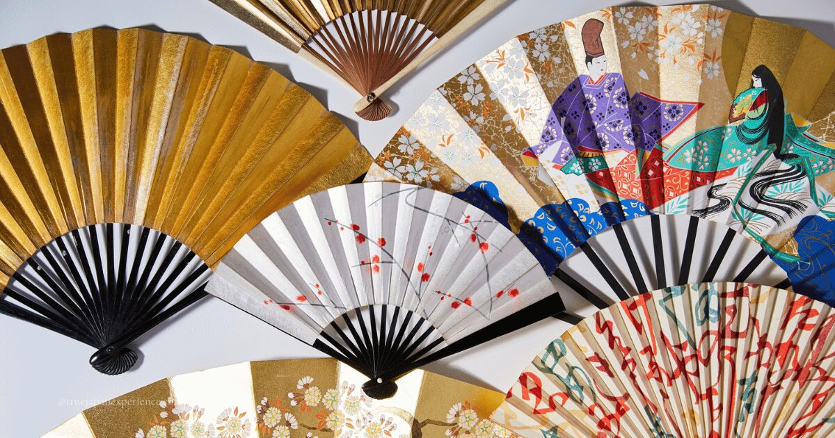 Japanese folding fans (sensu) with traditional designs, including gold patterns, cherry blossoms, and Heian-era figures