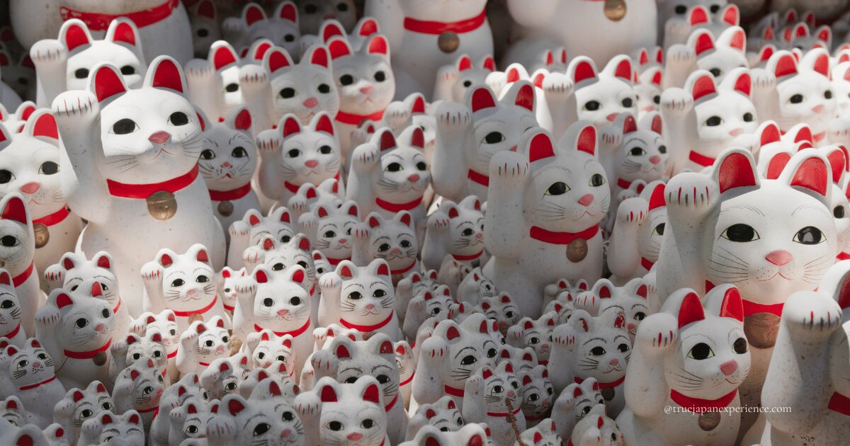 Hundreds of white Maneki-neko statues with raised paws at Gotokuji Temple in Tokyo, Japan.