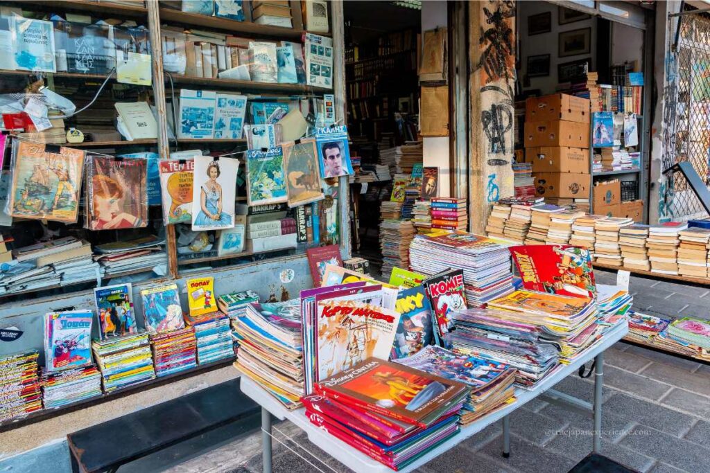 Stacks of secondhand manga and old magazines displayed outside a retro bookstore in Akihabara.