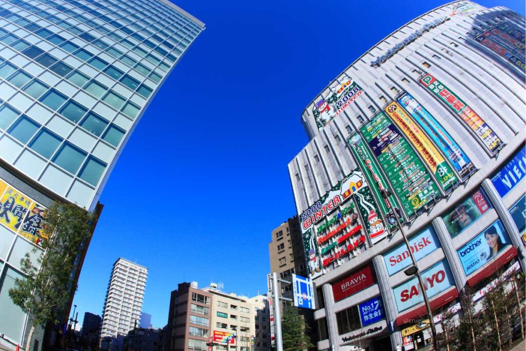 Akihabara’s Yodobashi Camera building and nearby modern offices under a clear blue sky in Tokyo.