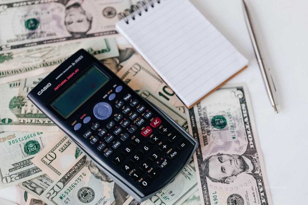 Money, calculator, and notebook on a desk