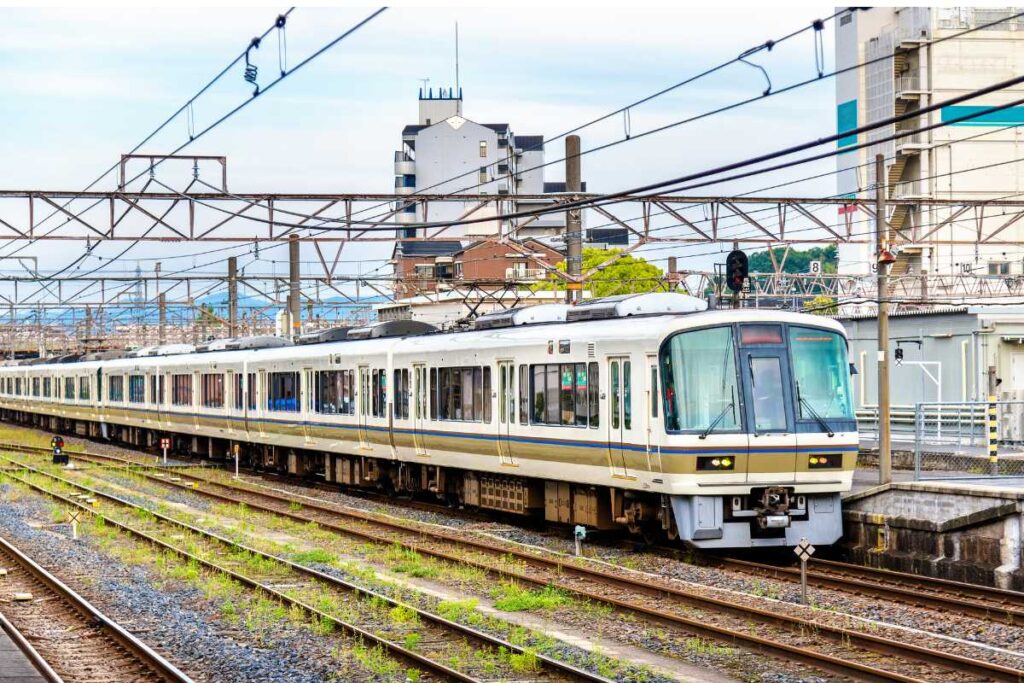 JR local train running on tracks in Japan near a station