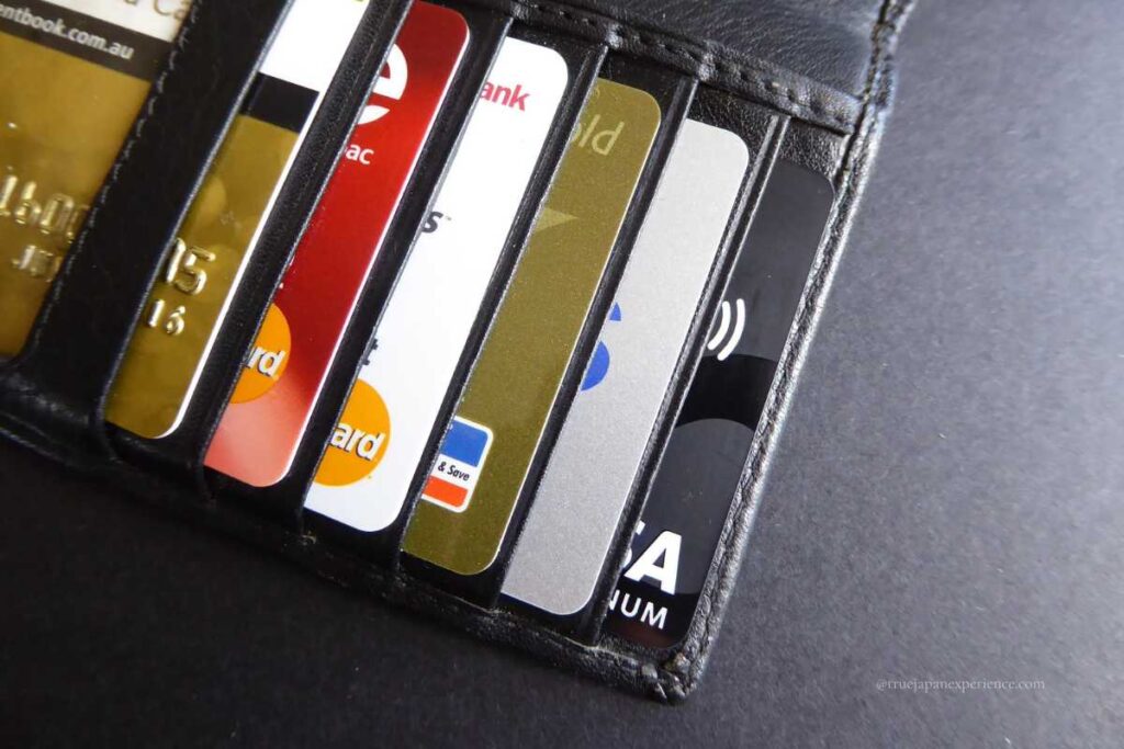 A close-up of a wallet with several credit and bank cards inside